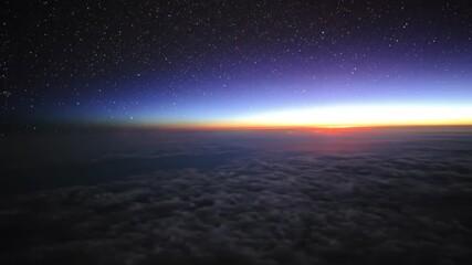 Sunset over clouds and starry sky aerial view background