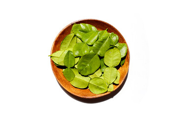 Kaffir lime leaves on white background.