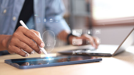 Deepfake detection and AI technology concept. Businessman using laptop and digital facial recognition interface for cybersecurity and identity verification.
