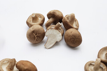 Fresh shiitake mushrooms on white background.