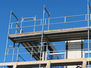 Naklejka premium Construction site photo, scaffolding, new building, increased interest rates, problems with house construction