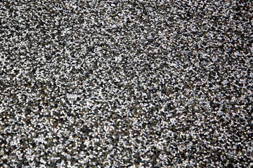 Close-up of textured pedestrian walkway surface made of small gravel.