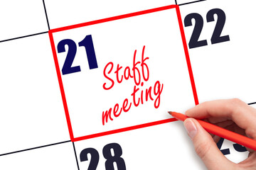 21 st day of the month.  Hand writing Staff meeting reminder and drawing red frame on calendar with...