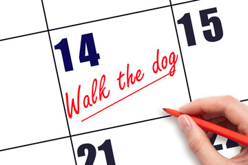14 th day of the month.  Hand writing Walk the dog reminder and drawing a line on calendar with red pen on white background. concept of caring for pets. Planning and scheduling