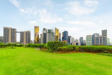 Fototapeta premium View of contemporary high-rise buildings across green lawn