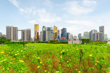 Fototapeta premium View of contemporary high-rise buildings across green lawn