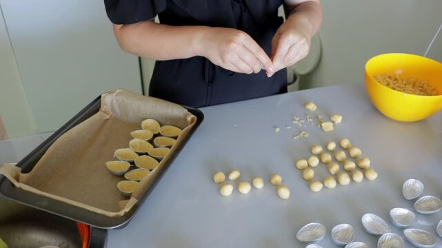 Colorful kitchen setup with filled tart shells awaiting baking, Prepping mini tart shells with precise placement of dough and filling in bright kitchen environment