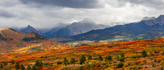 Super panoramic scenic view of Continental divide landscape in San juan mountains, Colorado with stormy clouds.