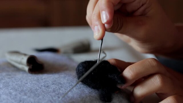 Participating in soothing wool sculpting through needle felting techniques, Engaging in tranquil wool crafting by needle felting to produce sturdy threedimensional forms