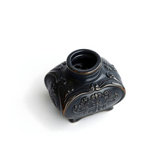 A delicate, antique ink pot with intricate engravings and a subtle sheen, placed centrally on a pristine white background