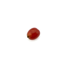 A solitary red grape is placed at the center of a pristine white background