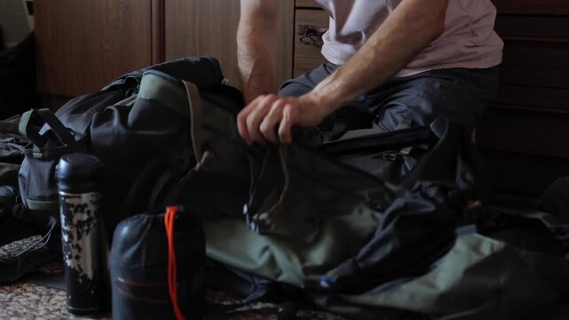 Packing for adventure, Preparation for outdoor expedition, Organized packing scene with gear and supplies, Structured travel arrangement with water bottles and equipment