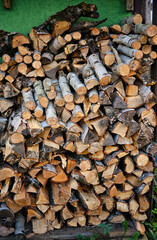 A stack of firewood in a woodshed outside