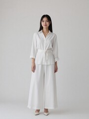 High-quality studio photo of a modern businesswoman in office outfit, smiling confidently with relaxed posture against a clean solid background, professional and elegant look
