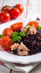 Close-up of a gourmet plate with tuna, rice, and ripe cherry tomatoes