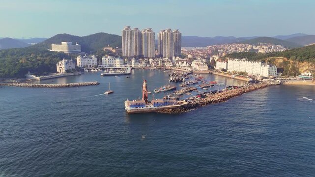 Orbit view of Dalian's fisherman wharf with mountains and city in the background