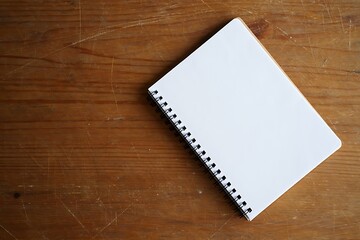 Blank spiral notebook open on a wooden surface