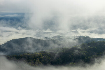 Landscape of Morning Mist with Mountain Layer. mountain ridge and clouds in rural jungle bush forestLandscape of Morning Mist with Mountain Layer. mountain ridge and clouds in rural jungle bush forest