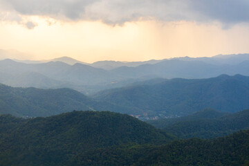 Landscape of Morning Mist with Mountain Layer. mountain ridge and clouds in rural jungle bush forest
