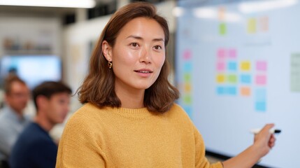 Woman giving presentation in classroom.