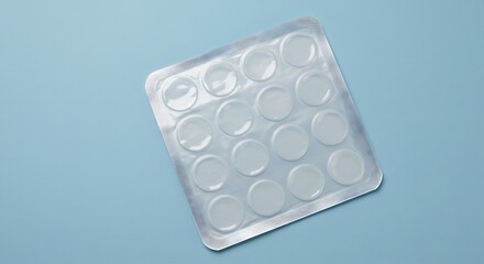 A clear blister pack containing 16 small, round, transparent gel pads on a light blue background for commercial usage and mockups