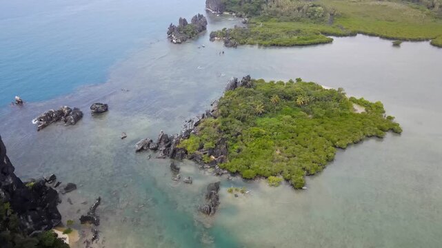 Drone aerial panning up at La Poule in New Caledonia with blue water