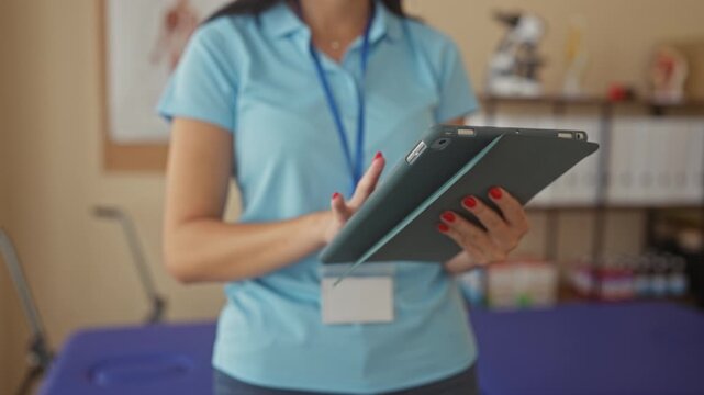 Woman taps tablet with finger in clinic while reviewing patient notes during therapy session; concentration.