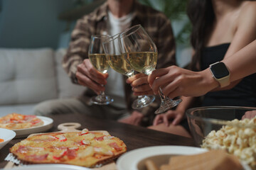 Friends toasting white wine glasses celebrating party togetherness