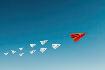 A vibrant image shows a red paper airplane leading a formation of white paper airplanes