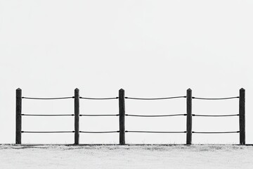 Minimalist grayscale image of a simple fence with horizontal ropes against a plain white sky