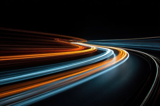Abstract image of motion blur depicting illuminated light trails in fiery orange and cool blue against black