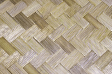 Natural brown bamboo background showing herringbone weave pattern. An abstract surface texture with rustic and organic feel, ideal for design and handicraft concepts
