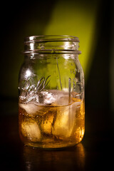 whiskey on the rocks served in a small mason jar