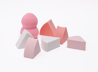 Assorted beauty blender and makeup sponges on a clean white background.