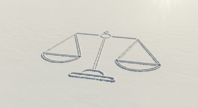 Scales of justice on snowy landscape for international day of abolition of slavery awareness - Powered by Adobe