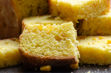 Homemade cornbread slices on kitchen table zoomed image