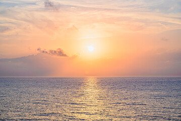 Obraz premium Beautiful orange sunrise sky over the sea horizon. Summer golden hour. 