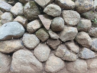 Stack of natural stones with rough texture and gray-brown tones.