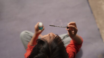 Little Girl Blowing Soap Bubbles Outdoors on a Sunny Day