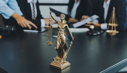 Judge gavel with Justice lawyers having team meeting at law firm background. Concepts of Law and Legal services.