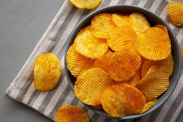 Crinkle Potato Chips with Chorizo Sausages and Onions Flavor in a Bowl, top view.