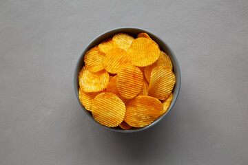 Crinkle Potato Chips with Chorizo Sausages and Onions Flavor in a Bowl, top view.