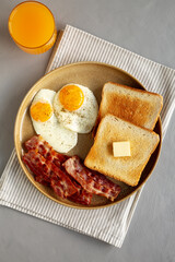 Homemade American Bacon Egg and Toast Breakfast on a Plate, top view.