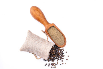 Black peppercorns and ground black pepper powder on white background	