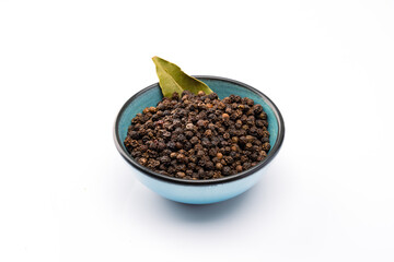 Black peppercorns on white background	