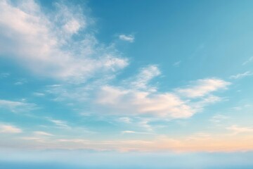 Obraz premium Expansive serene sky with scattered soft clouds at dawn or dusk over calm horizon