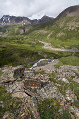 A view of a green valley with rivers flowing down the slopes