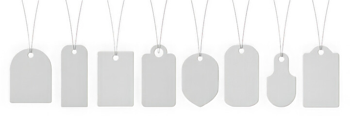 Collection of various blank white price tags hanging on strings isolated on transparent background.