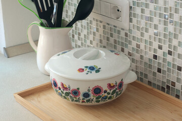 Retro-style ceramic bowl with floral patterns. Interior design and style. Mosaic tiles and kitchen countertops.