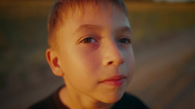 Little boy looking at sky and dreaming of future and flight, closeup portrait. Happy childhood, cute caucasian preschooler child walking alone in park adn admiring nature, good mood and dreams